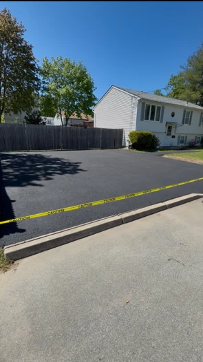 Freshly sealcoated asphalt driveway